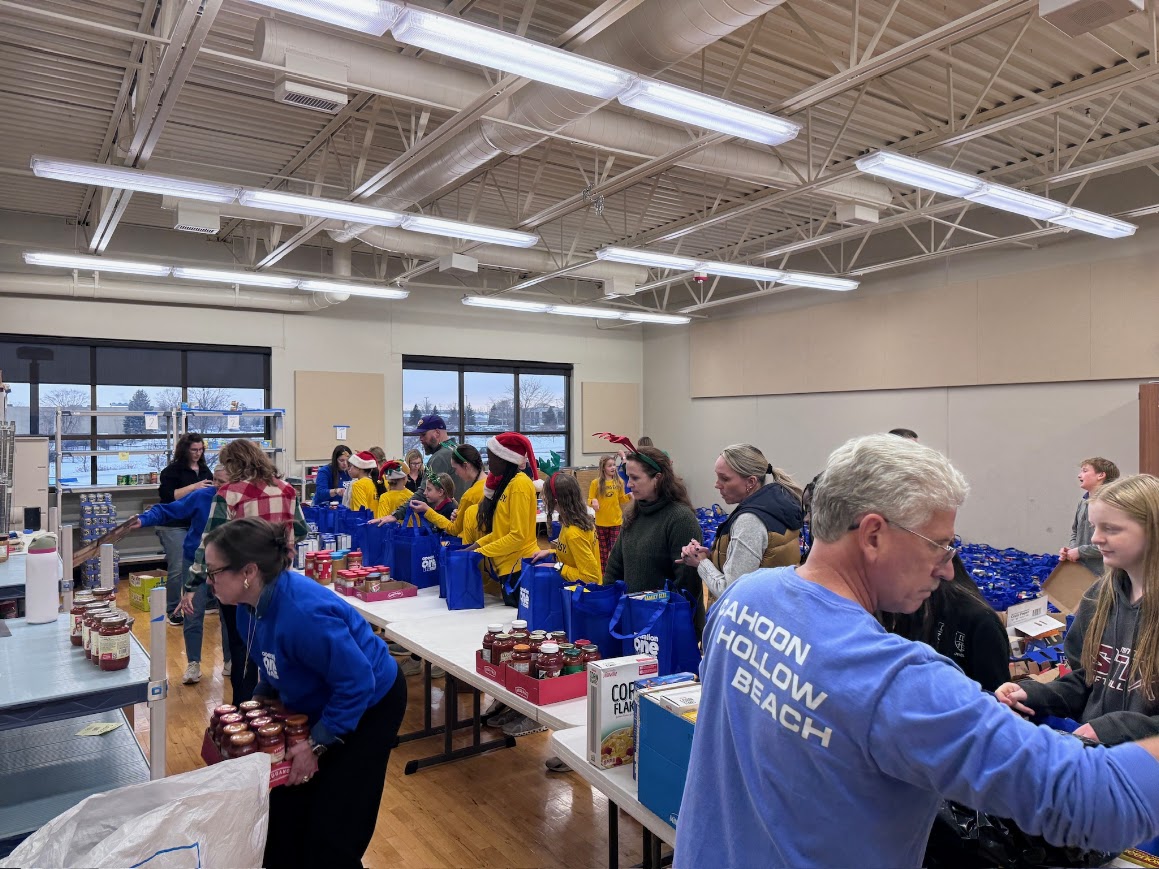 Operation One More volunteers packing groceries
